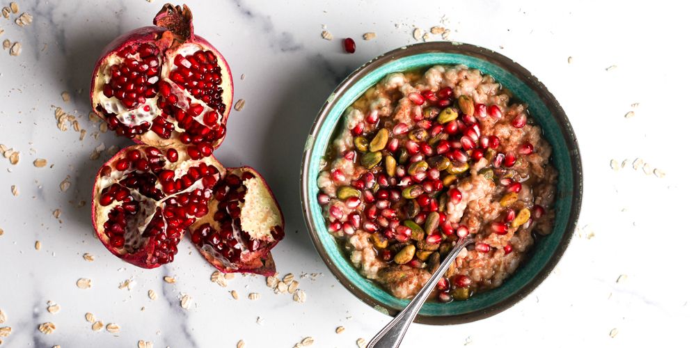 bowl of oatmeal with pistachios and pomegranate seeds