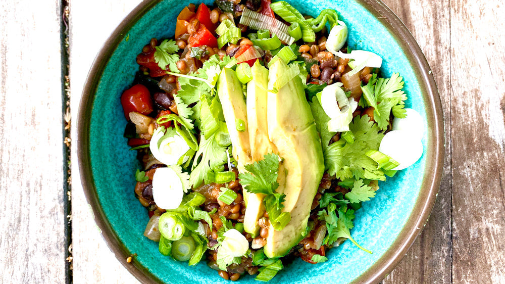grain bowl with avocado, cilantro and tomatoes