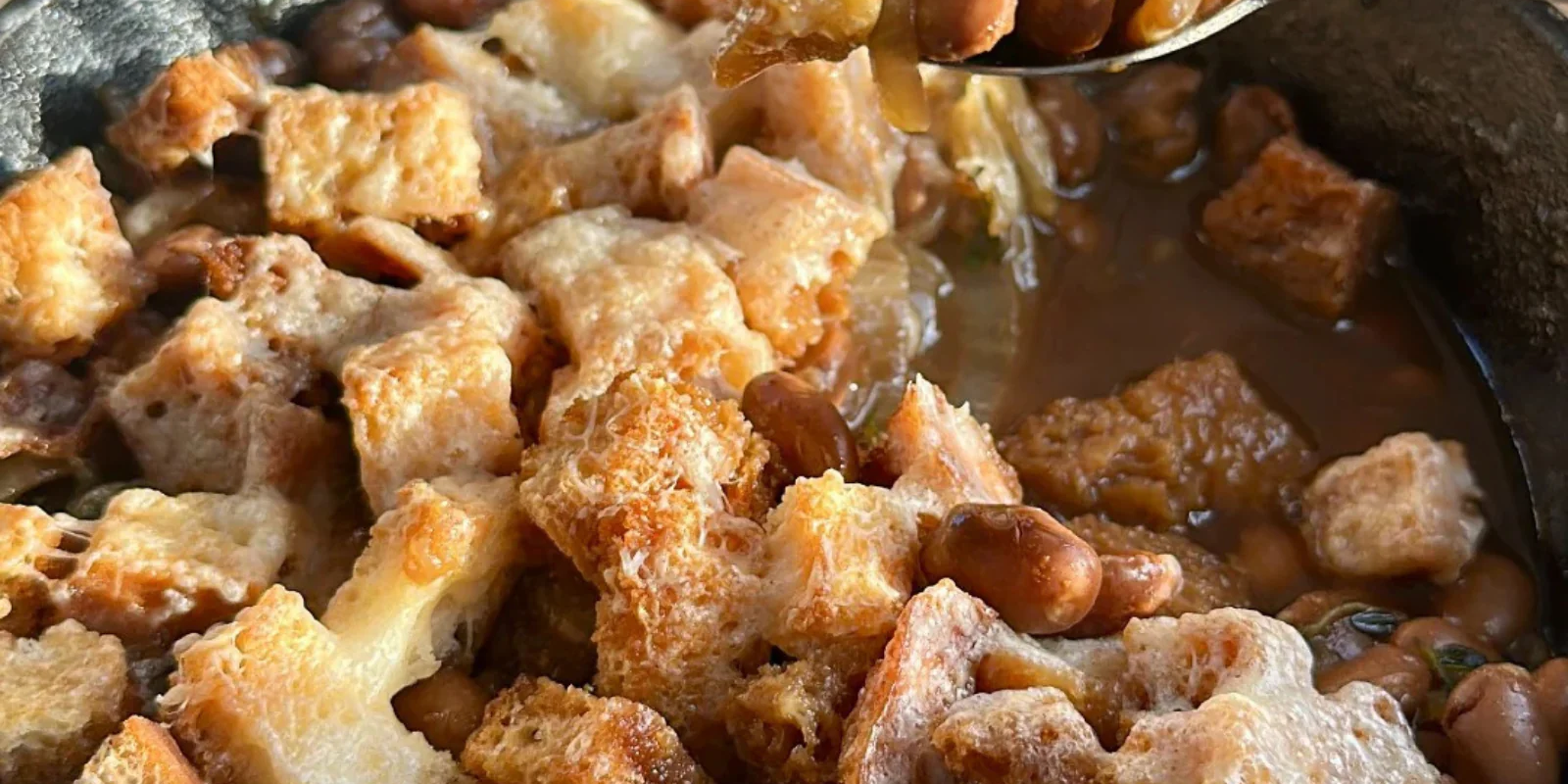 cheesy beans and croutons in broth