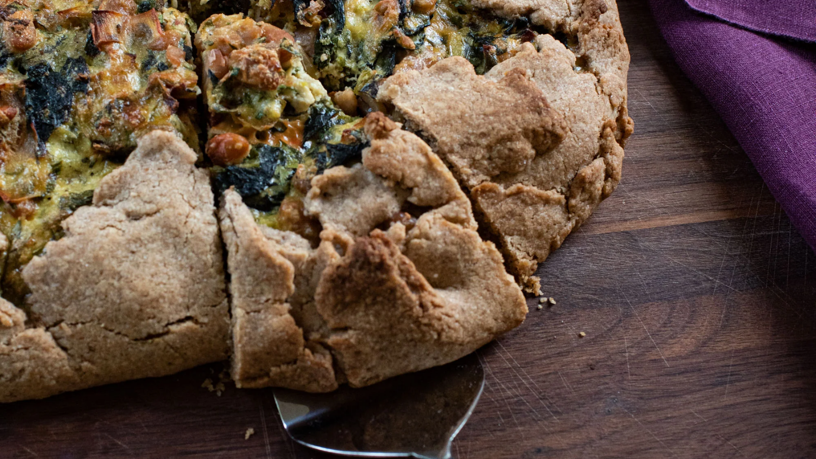 crostata with vegetables and beans on wood table