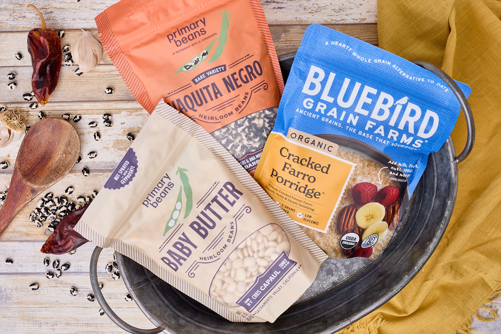two bags of beans and one bag of grains arranged decoratively