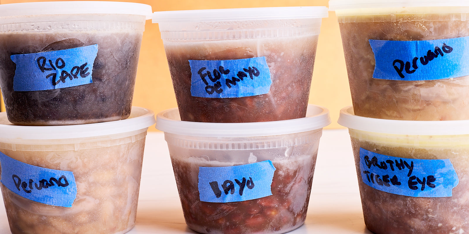 tubs of frozen heirloom beans with blue labels