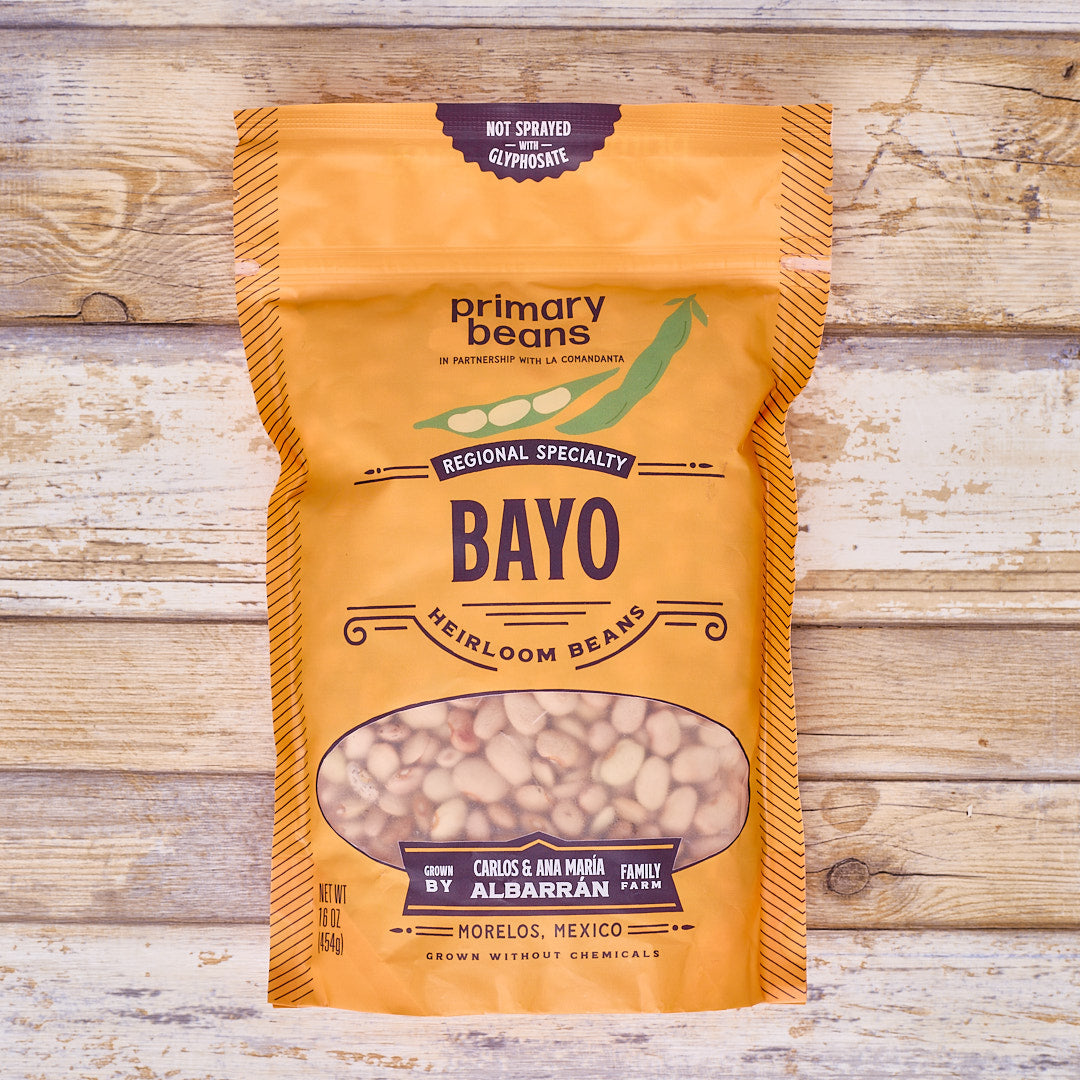 Bag of 'primary beans' Bayo heirloom beans on a wooden background
