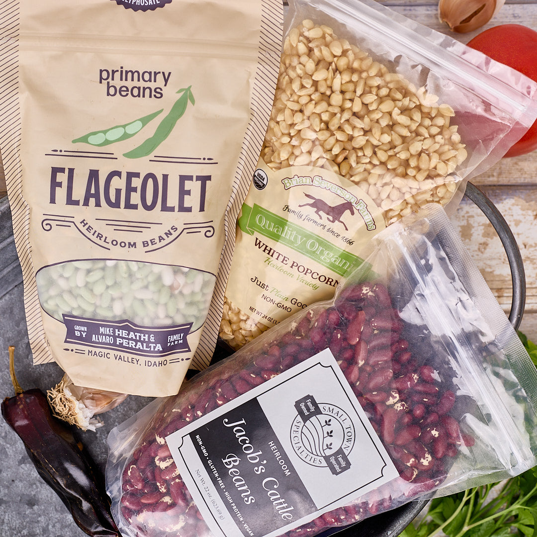 2 bag of beans and 1 bag of grains on a counter