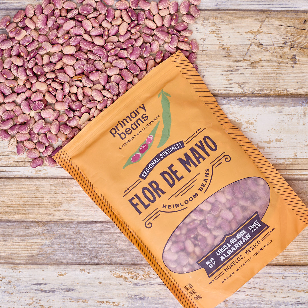 Packaged flor de mayo heirloom beans from Primary Beans on a wooden surface