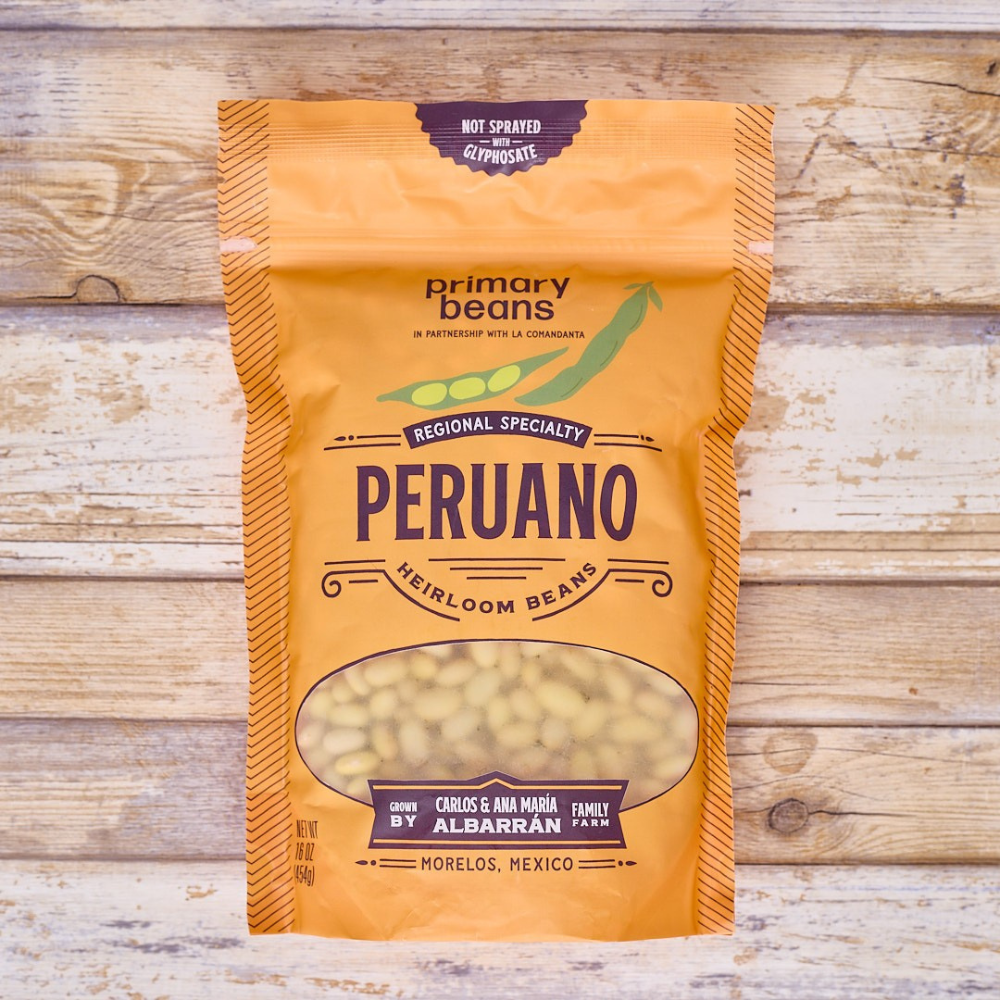 package of heirloom peruano beans on wood surface