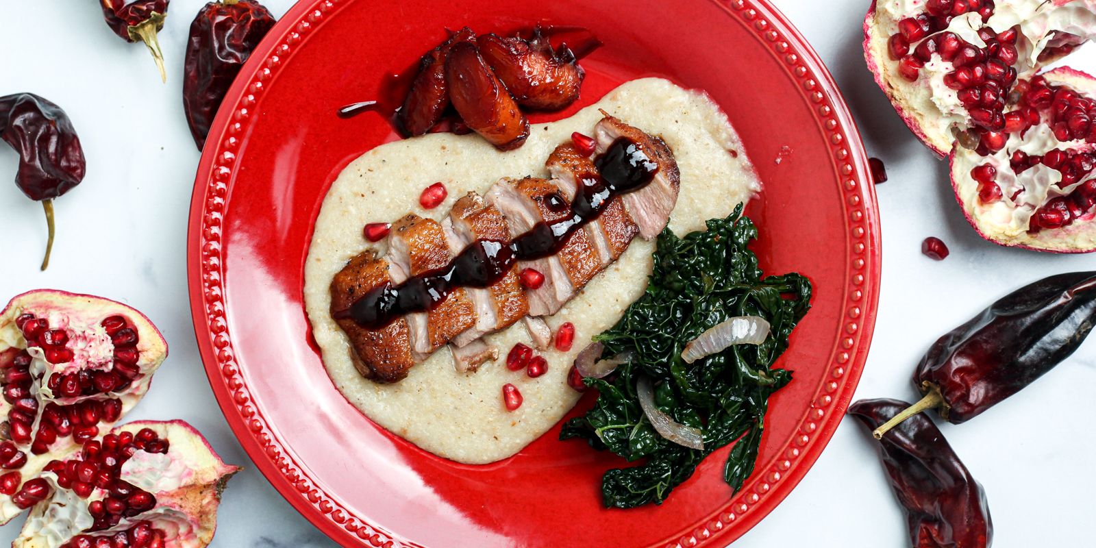SEARED DUCK BREAST WITH POMEGRANATE CHILI SAUCE OVER SMOKY GRITS