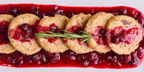 Fried polenta cakes topped with a vibrant cranberry juniper sauce