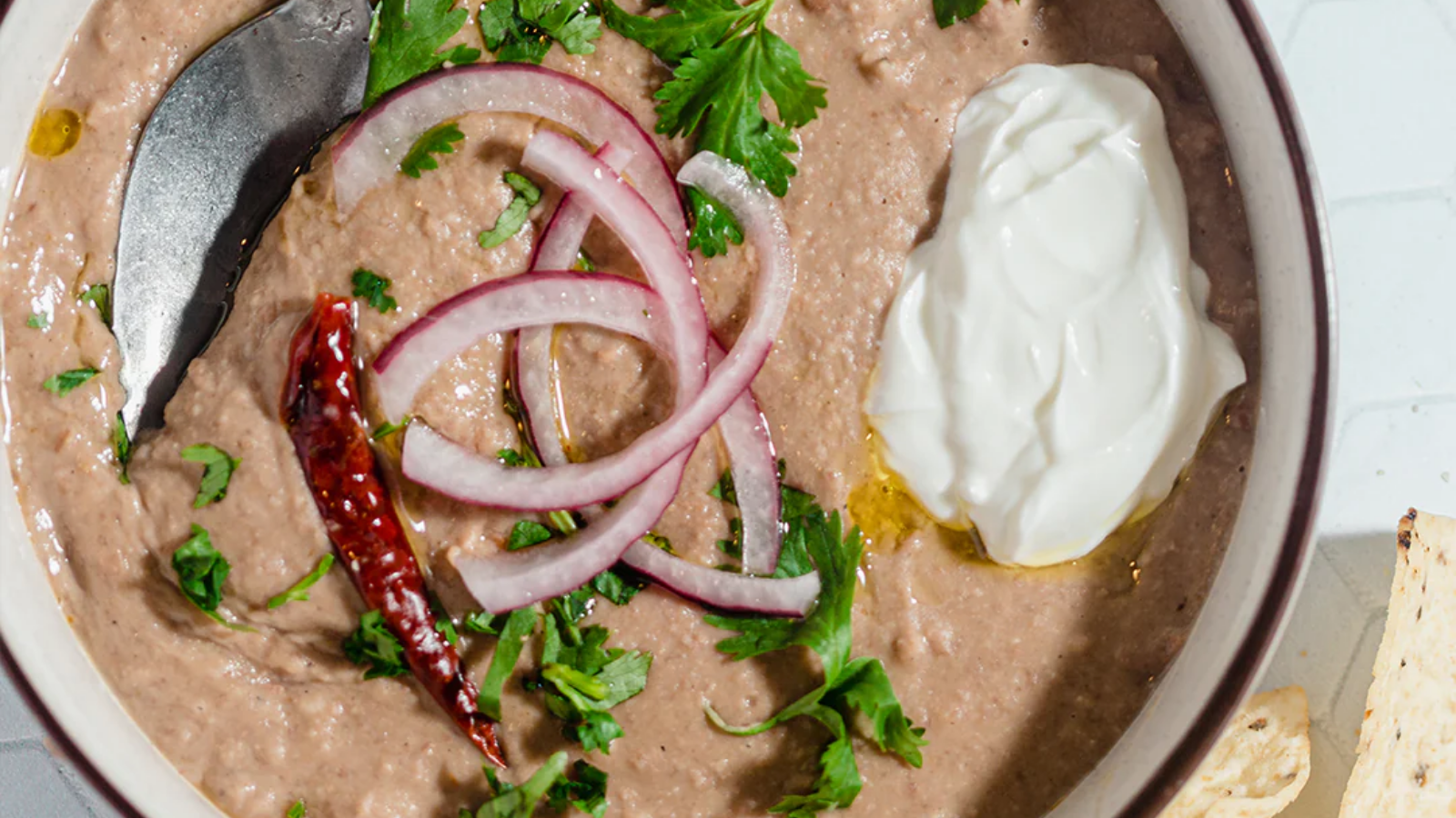Mexican-inspired refried beans with pickled onions