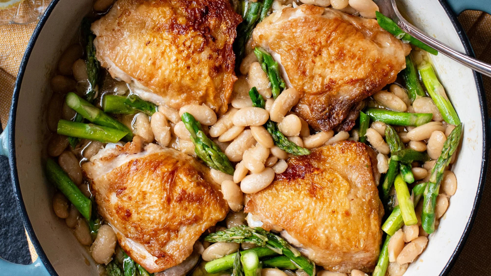 Crispy chicken thighs with braised beans and asparagus
