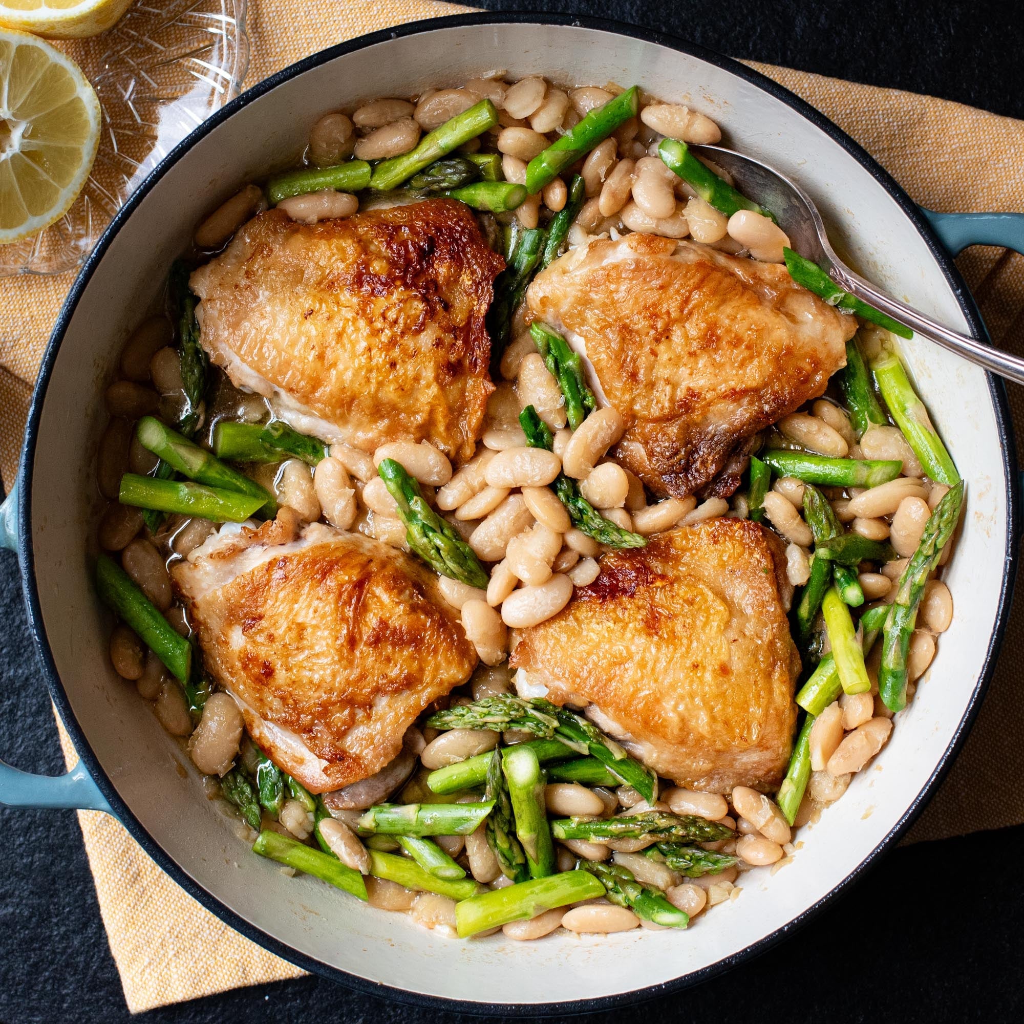 Crispy chicken thighs with braised beans and asparagus