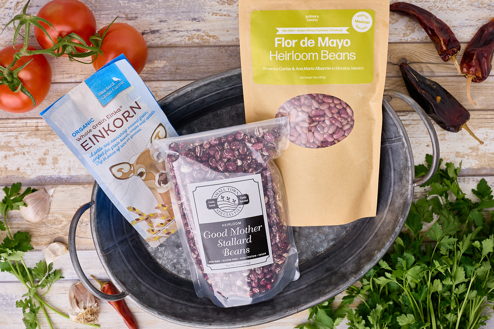 March heirloom bean and grain club selections in a galvanized tub on a wood surface.