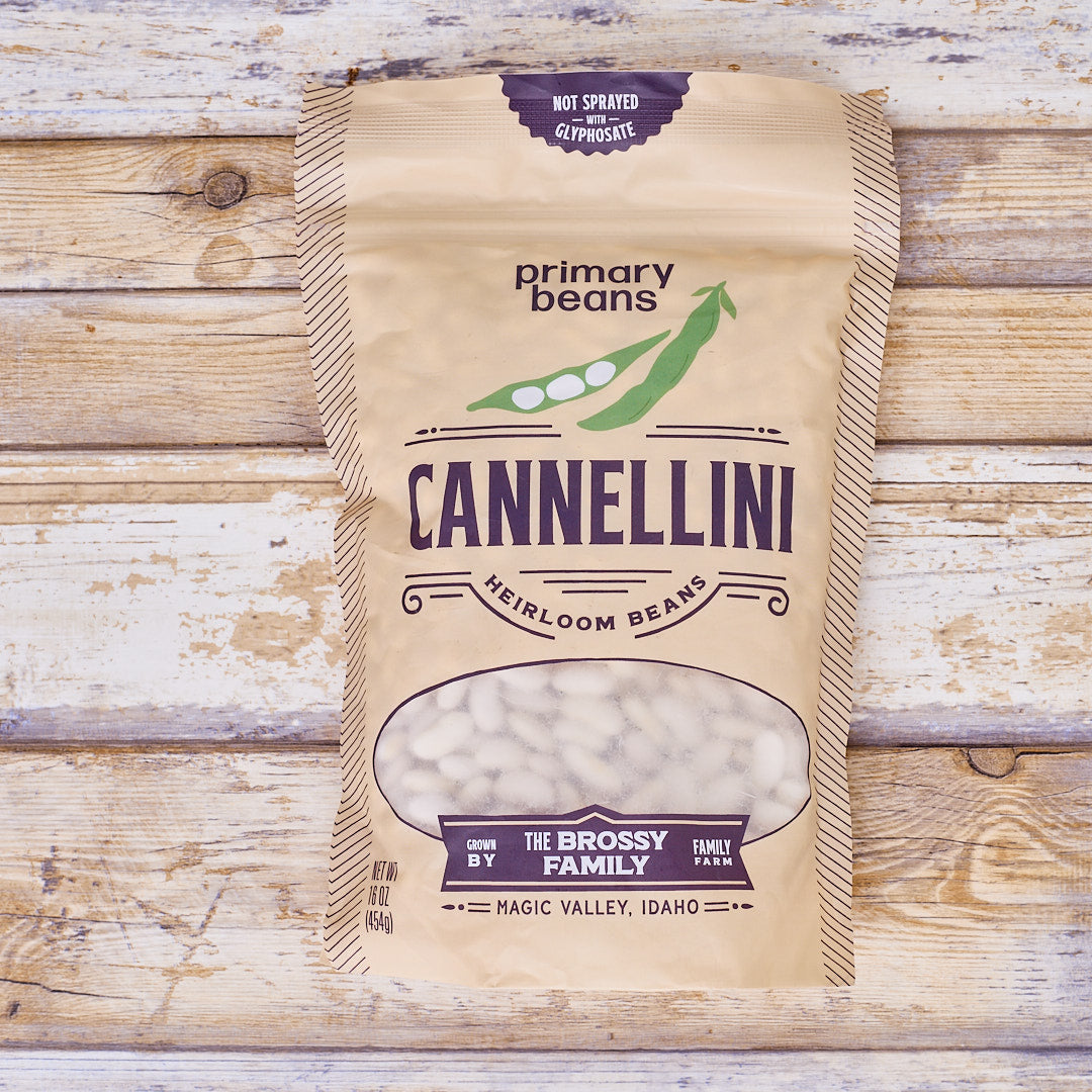 Bag of Primary Beans Cannellini heirloom beans on a wooden surface