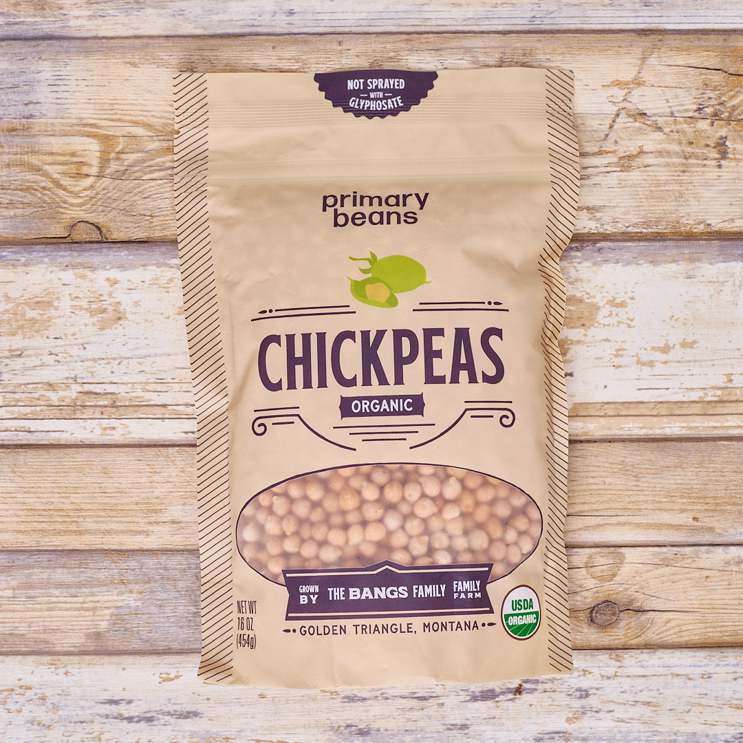 Bag of organic chickpeas from Primary Beans on a wooden background