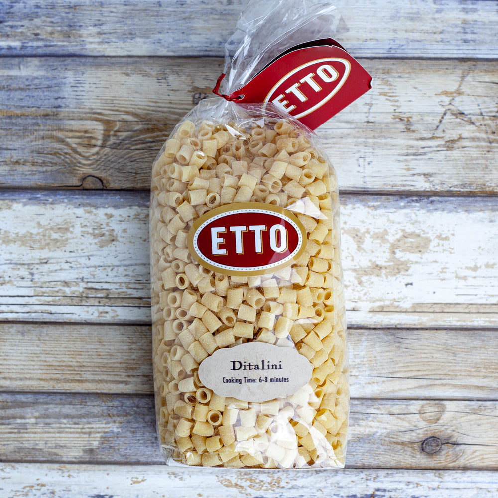 ditalini pasta from etto in clear bag on wood background