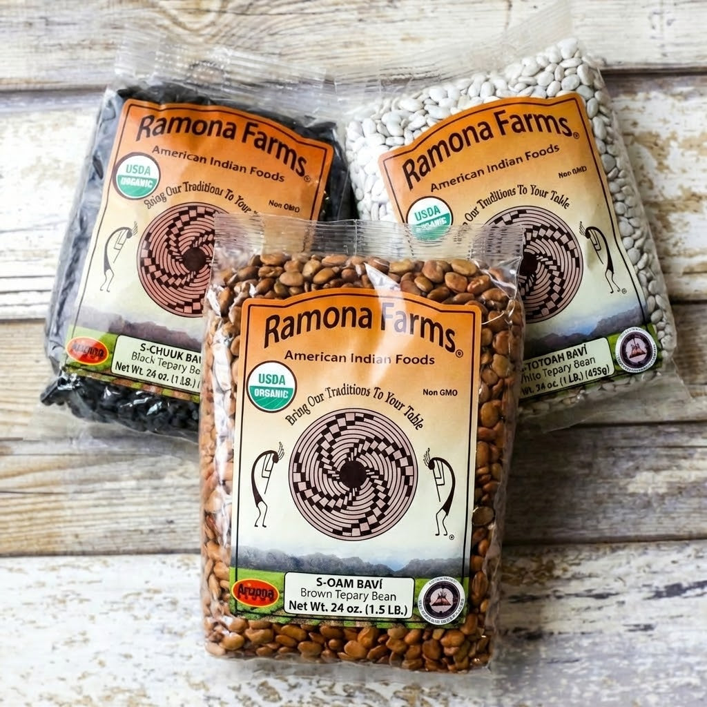 three packages of tepary beans on a wood surface